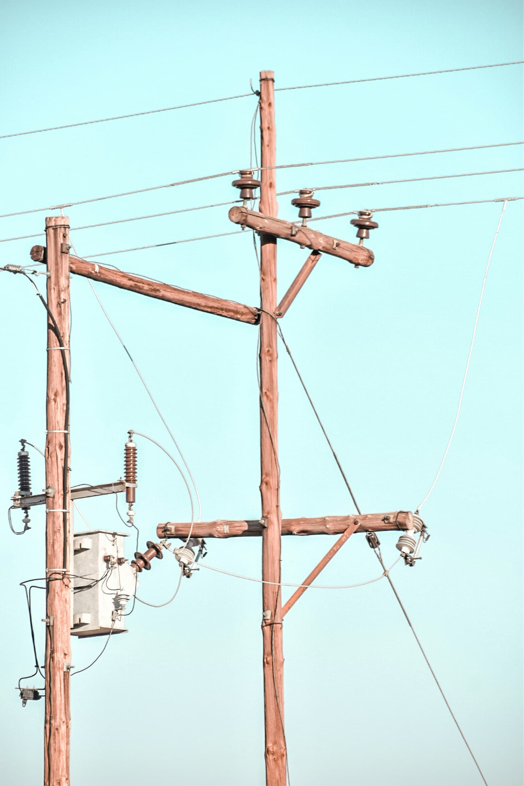 Utility grid power poles illustrating unreliable electricity infrastructure